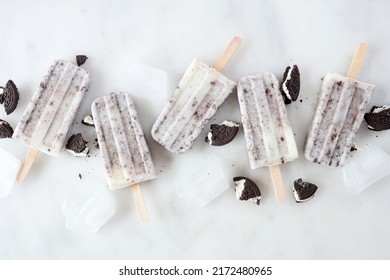 Cookies And Cream Ice Pops Scattered Over A White Marble Background