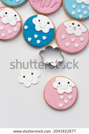 cookies decorated with fondant of a cloud with a smiley face. Tea paste to celebrate christening. Modeling paste craft. 