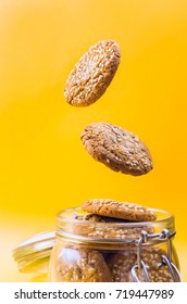 Cookies Flying Out Of A Glass Jar. Selective Focus.