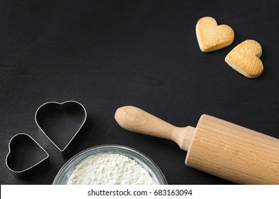 Cookies in heart shape lying after baking decorative with rolling pin and biscuit cutter - Powered by Shutterstock