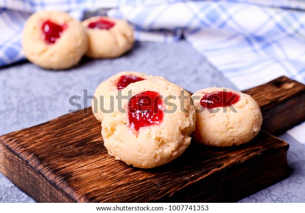 Cookies with jam, biscuits on a brown desk,
close up, horizontal