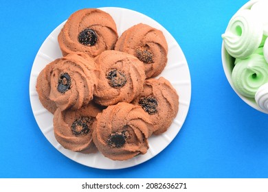 Cookies With Jam And Multi-colored Souffle In White Plates On A Colored Background. Top View, Flat Lay.