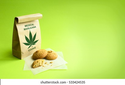 Cookies Of Medical Marijuana In The Kraft Bag. Green Background.