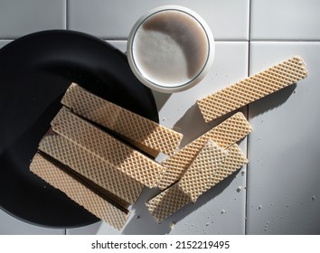 Cookies On A Black Plate And On A White Table, With A Glass Of Cold Milk On The Side, Lit By The Sunlight Coming From A Windowtop View Overhead Or Flat Lay Shot 