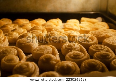 Cookies from puff pastry with sugar baking process in the oven. The concept of homemade baking. Horizontal orientation. Selective focus