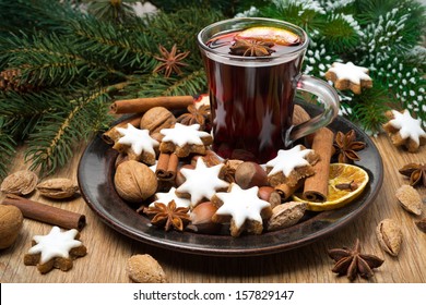 cookies in the shape of stars, spices and mulled wine on a plate, horizontal - Powered by Shutterstock