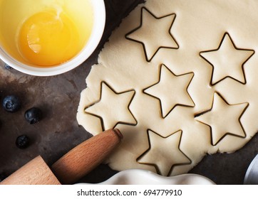 Cookies stars cut out of the dough, preparation before baking. Top view - Powered by Shutterstock