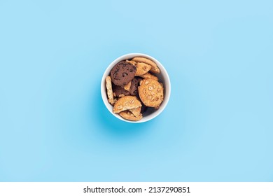 Cookies in a white bowl on a blue background. Top view, flat lay - Powered by Shutterstock