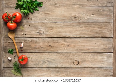 Cooking background, home cooking concept. Ripe tomatoes, spoon, herbs and spices on wooden background, top view, copy space. - Powered by Shutterstock