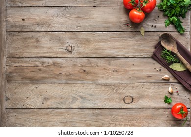 Cooking background, home cooking concept. Ripe tomatoes, spoon, herbs and spices on wooden background, top view, copy space. - Shutterstock ID 1710260728