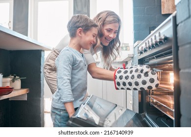 Cooking and baking is both physical and mental therapy. Shot of a little boy and his mother sitting in front of the oven. - Powered by Shutterstock