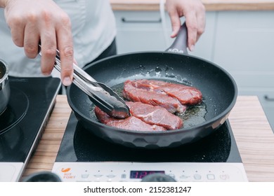 Cooking beef ribeye steak in a frying pan in the cooking class. Steak with spices. Cooking process, close-up. - Shutterstock ID 2152381247