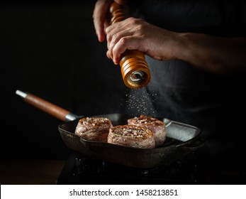 Cooking beef steak on grill pan by chef hands on black background for copy space text restaurant menu, - Shutterstock ID 1458213851