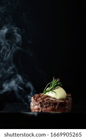 Cooking Beef Tenderloin Steak On A Grill Pan On A Black Dark Background With The Text Copy Space. The Concept Of The Recipe , Filet Mignon