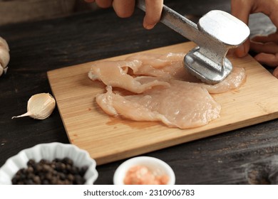 Cooking Breast Chicken Meat, Beat Chicken using Meat Tenderizer. Cooking Process in The Kitchen. - Powered by Shutterstock