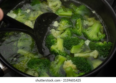 Cooking Broccoli In A Black Pot