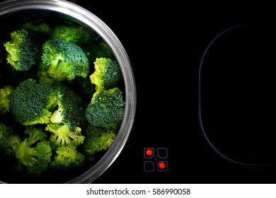 Cooking broccoli on ceramic hob. Healthy Life Concept.