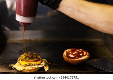 Cooking a burger by adding sauce to cream cheese.  - Powered by Shutterstock