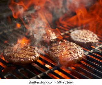 Cooking Burgers On Hot Grill With Flames