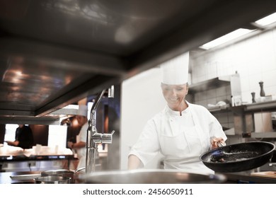 Cooking, chef and happy woman in kitchen at restaurant for fine dining, service and hospitality. Expert, culinary professional and worker with pan for meal prep, dinner or frying food for catering - Powered by Shutterstock