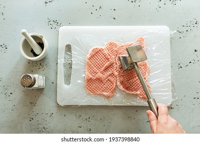 Cooking - Chef Tenderizing Raw Meat Slice By Pounding With Mallet. Preparing Pork Chop - Worktop Captured From Above (top View, Flat Lay).