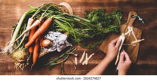 Cooking - Chef's Hands Preparing Fresh Raw Root Vegetables (carrot, Parsnip, Celeriac, Leek). Rustic Kitchen Scenery - Wooden Worktop Captured From Above (top View, Flat Lay). 