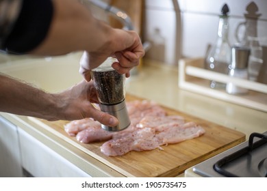 Cooking Chicken Breast. Hands Of Man Hands Sprinkle Chicken Breast With Pepper. Diy Four. Step By Step