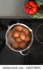 Cooking Chicken Eggs In Pot On Electric Stove, Top View