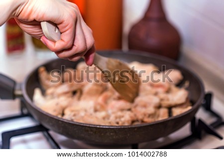 Cooking chicken fillet on frying pan