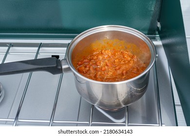 Cooking Chili In A Silver Pot On An Outdoor Propane Camping Stove