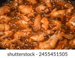 Cooking Chinese cuisine Coca cola chicken wings in a pot, heating and bubbling