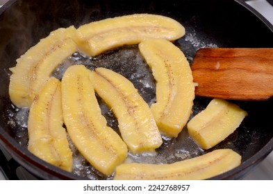 cooking chinese dessert bananas are fried in a frying pan - Shutterstock ID 2242768957
