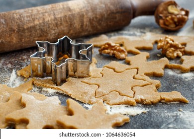 Cooking Christmas cookies with  cookie cutters on a dark table - Powered by Shutterstock
