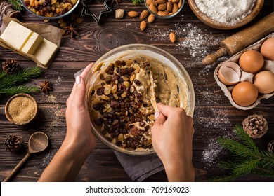 Cooking Christmas Fruit Cake.  Young Woman's Hands Mixing Ingredients In Bowl. Wooden Table. Top View