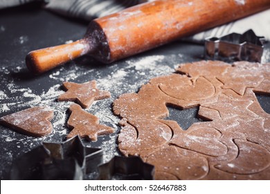 Cooking Christmas gingerbread cookies on a dark background