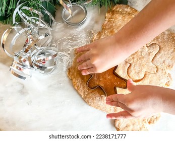 Cooking Christmas gingerbread. The cooking process, dough, rolling pin, whisk, gingerbread man. A child cooks gingerbread, cooking with a child. 