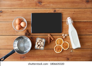 Cooking, Christmas And Seasonal Drinks Concept - Tablet Pc Computer, Ingredients For Eggnog, Pot On Wooden Background