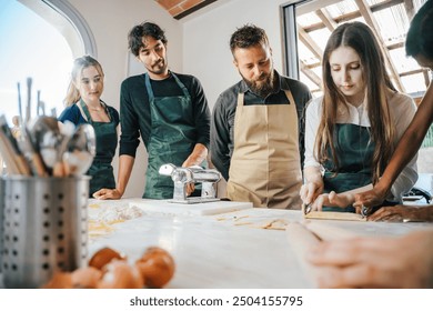 Cooking class, culinary experience of preparing ravioli, a typical Italian dish - Group of students attend the course practicing under the supervision of the chef - Powered by Shutterstock