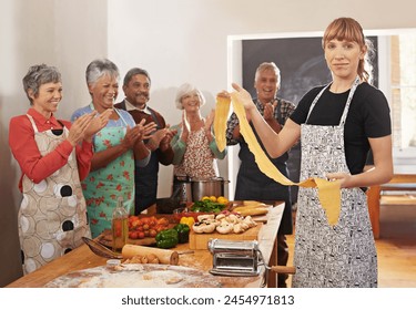 Cooking class, pasta and portrait of people in kitchen learning recipe for cuisine, culinary and chef skills. Celebration, applause and happy men and women with ingredients, dough and food for dinner - Powered by Shutterstock