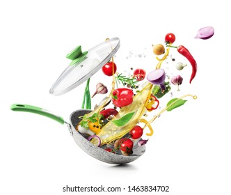 Cooking concept. Vegetables are flying out of the pan isolated on white background. Healthy food.