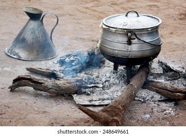 Cooking corn cereal in contrule on fire in the village, Botswana