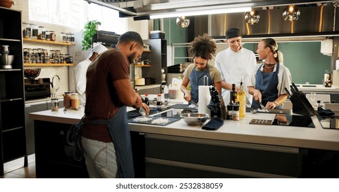 Cooking course, chef and people learning in kitchen for knife skills, cutting technique and practice. Culinary class, students and mentor with lesson on onion preparation and education in hospitality - Powered by Shutterstock