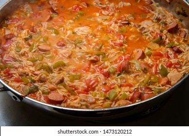 Cooking Creole Pot Of Chicken And Andouille Sausage Jambalaya With Rice