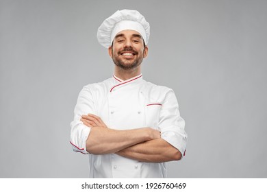 cooking, culinary and people concept - happy smiling male chef in toque and jacket over grey background