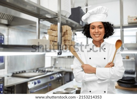 Foto Bild Koch in schwarzer Uniform schneidet ein Stück Brot ab.