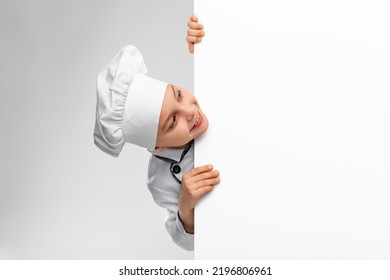 Cooking, Culinary And Profession Concept - Happy Smiling Little Boy In Chef's Toque And Jacket With White Board Over Grey Background