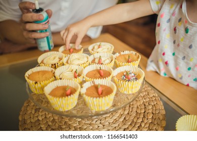 Cooking Cupcakes With Kids, Kid Decorating Cupcakes On A Glass Plate On A Table