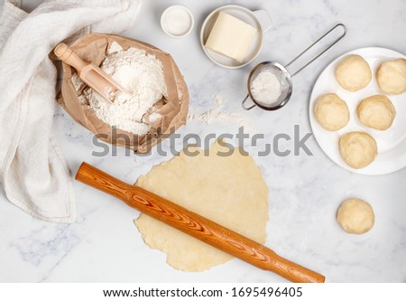 Similar – Image, Stock Photo baked round white wheat bread on a textile towel