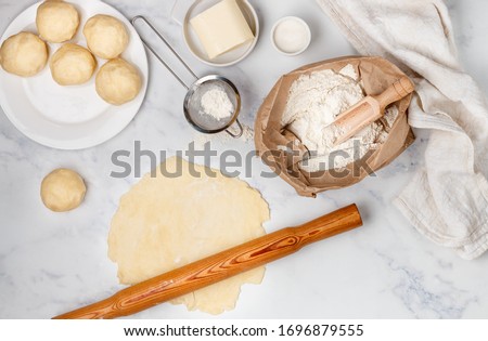 Similar – Image, Stock Photo baked round white wheat bread on a textile towel