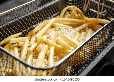 Cooking delicious french fries in hot oil, closeup - Powered by Shutterstock